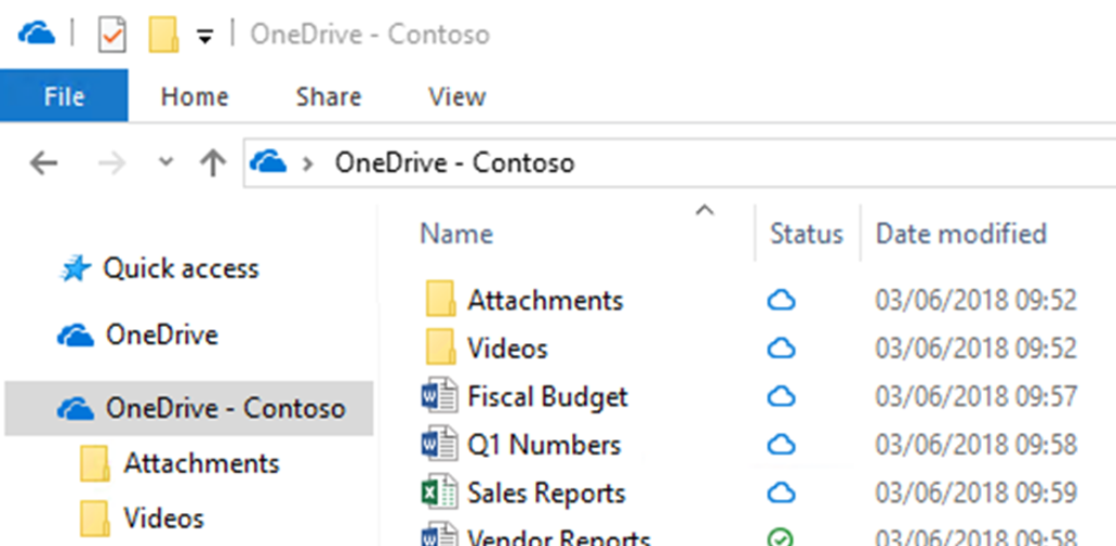 Image of the OneDrive folder "OneDrive - Contoso" in File Explorer, showing folders for "Attachments," "Videos," "Fiscal Budget," and "Q1 Numbers" with files like "Sales Reports" and "Vendor Reports."